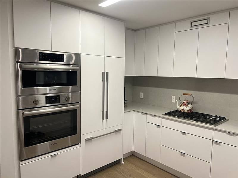 Convection oven/microwave and conventional oven. Gas range. Fisher-Paykel Refrigerator.