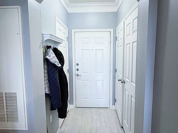 Condo Entrance, new floor (washing/dryer on the right and closet to left)