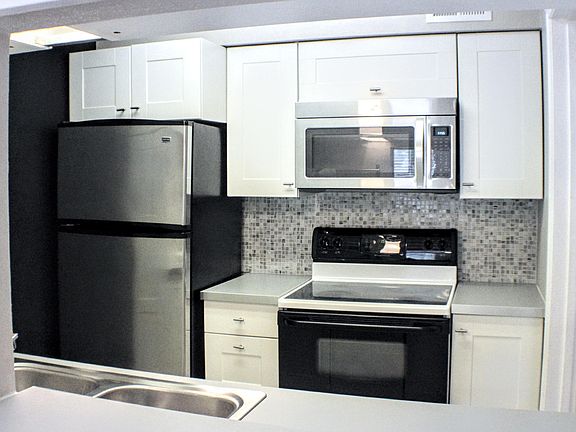 Stainless steel Refrigerator & Microwave. Flat-top Oven Stove