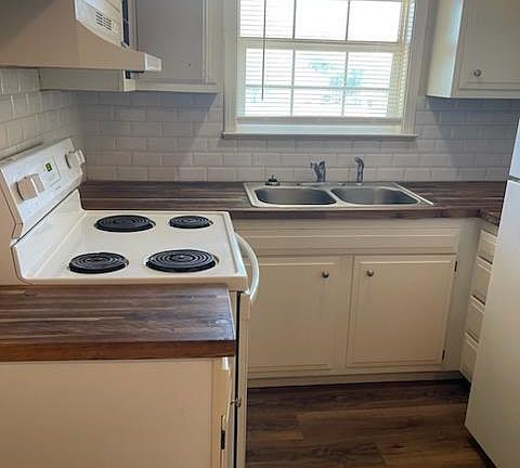 Updated kitchen with subway tile back splash and butcher block counter tops.