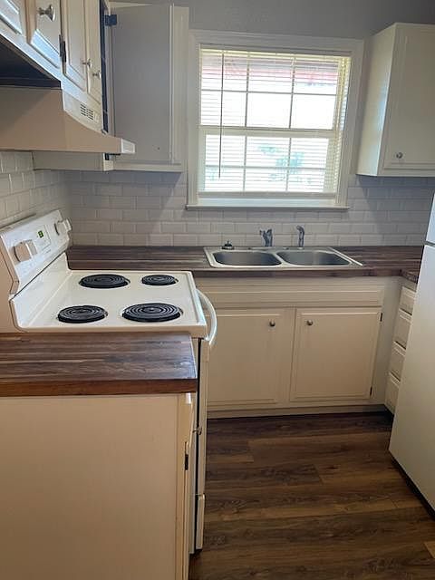 Updated kitchen with subway tile back splash and butcher block counter tops.