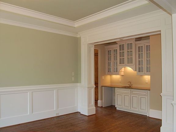 Dining Room with trey ceiling and heavy moulding open to butler’s pantry 