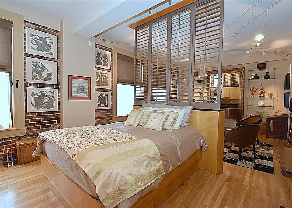 Exposed brick walls visible from the bedroom offer an amazing true loft feel to this unit.