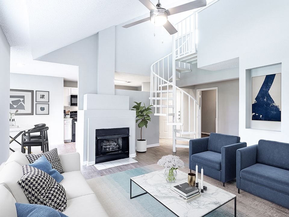 Sophisticated living room with a fire place and spiral loft stairs