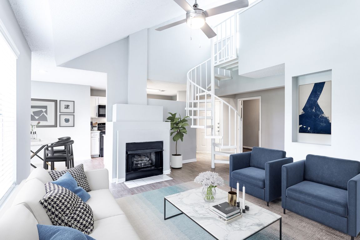 Sophisticated living room with a fire place and spiral loft stairs