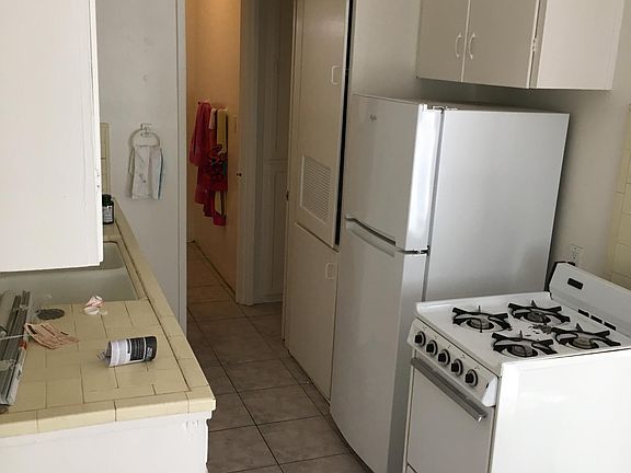 Kitchen with stove and refrigerator