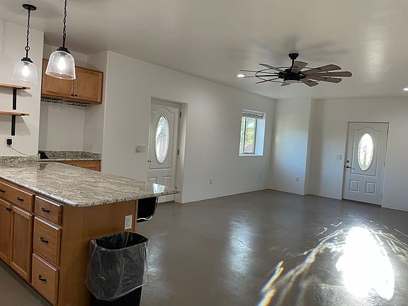Living Room/Dining Room/Kitchen Great Room. Main access door on right, patio/yard access door on left has a screen door.
