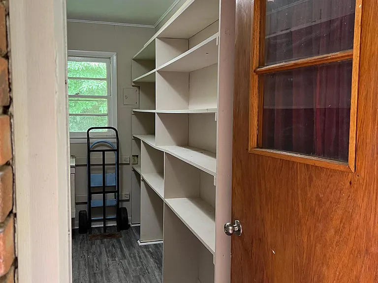 Lots of shelving for storage in laundry room