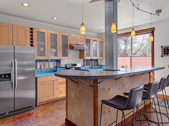 Very fun and functional kitchen all around! Custom poured concrete island and kitchen countertops. 
New leather barstools. 
Gas stove with new venting hood fan.