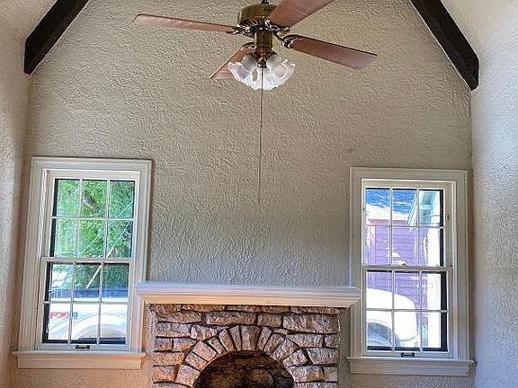 Living room has cathedral beamed ceiling with gas log fireplace. Fireplace recently inspected.