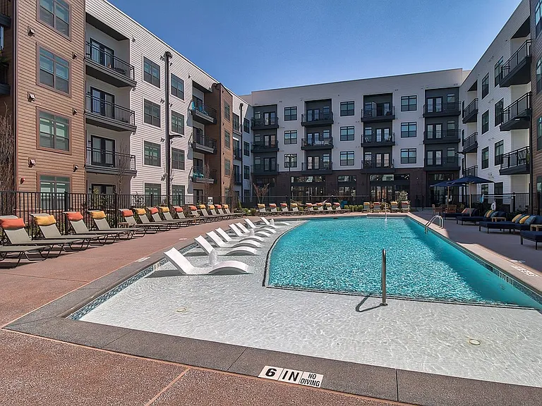 Resort-style saltwater pool with sundeck and poolside cabanas