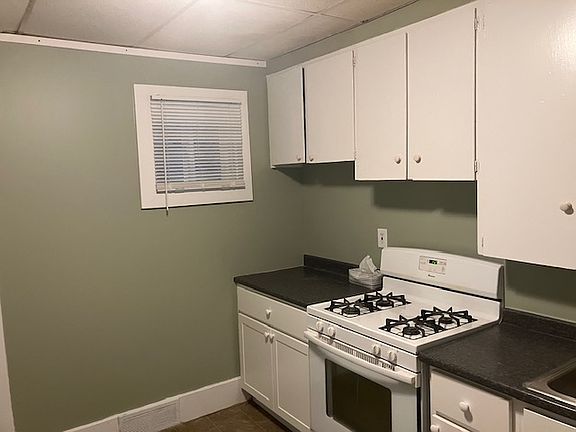 West side of kitchen with new window, counter, and lower cabinets
