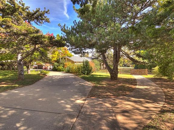 A large concrete drive circles around the home and there is good access to the backyard (gate is visible above). Beautiful trees abound, making it shady and beautiful in the summer, and so pretty in the fall!