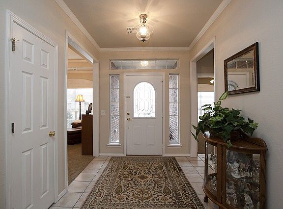 Well lighted tiled entery with coat closet.