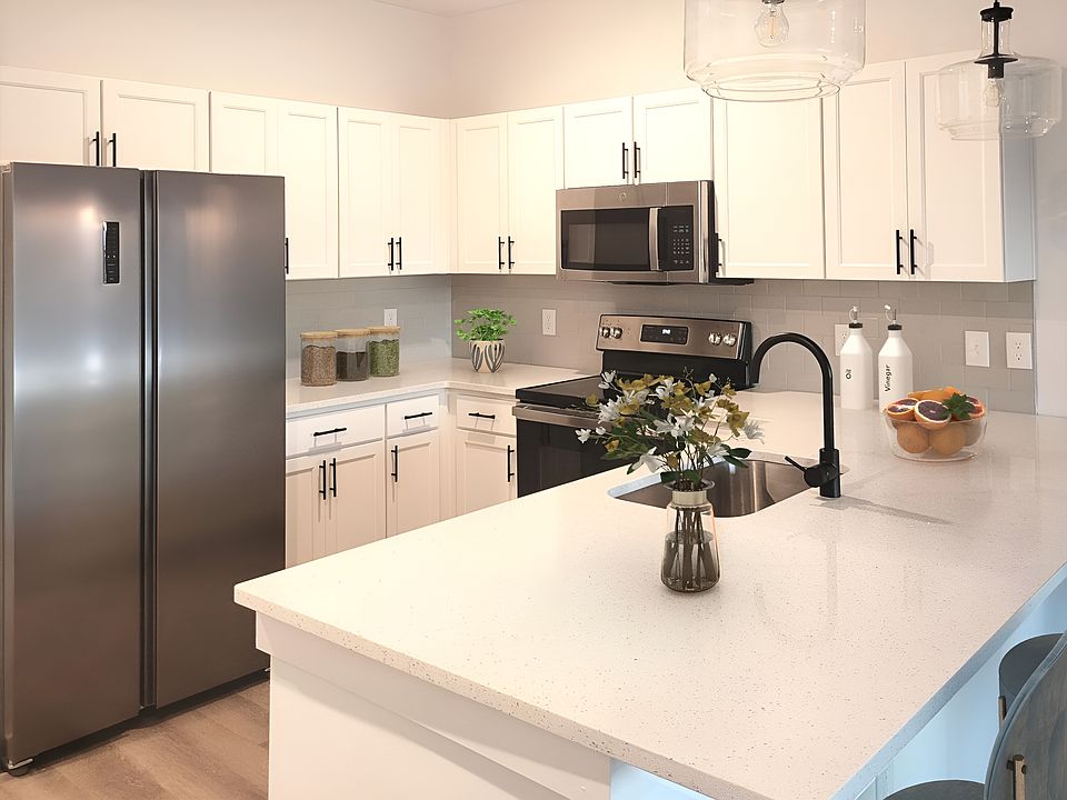 Open floorplan kitchen with dedicated pantry closet at entry.