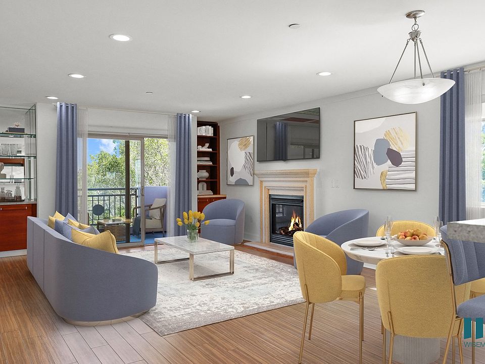 Open-Concept Kitchen, Dining, and Living Room Space with Patio and Built-In Shelving