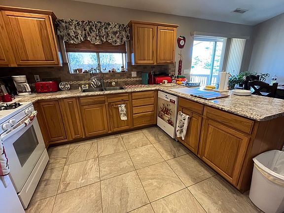 Large, fully equipped kitchen, open to dining room with door onto large covered deck.