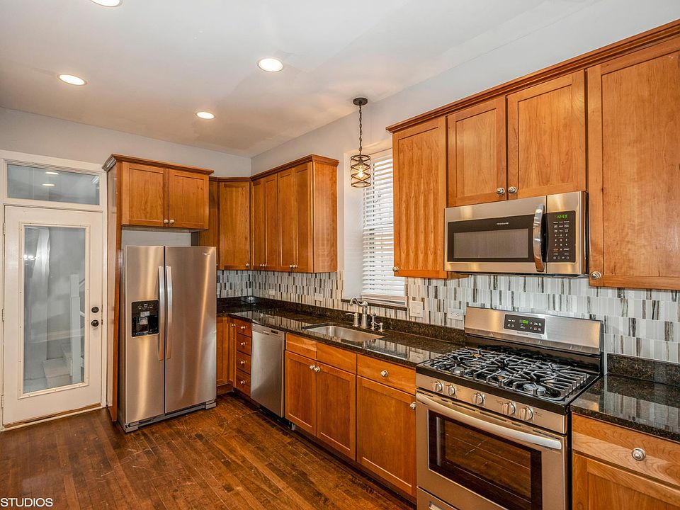 Eat-in kitchen with SS appliances, granite countertops and cherry wood cabinets