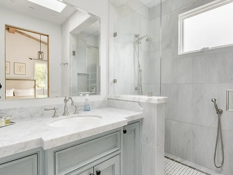 marble shower with both hand shower and rain shower head