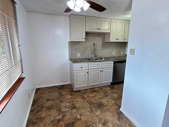 Charming kitchen with modern amenities, featuring sleek countertops, stainless steel appliances, and ample cabinet space in a 1 bed, 1 bath apartment for $1,250/month.