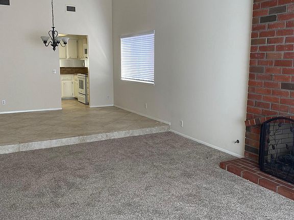 Upon entering the front door you step into the living room and formal dining room with vaulted ceilings