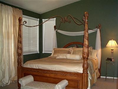 Master suite with ceiling fan and vaulted ceing