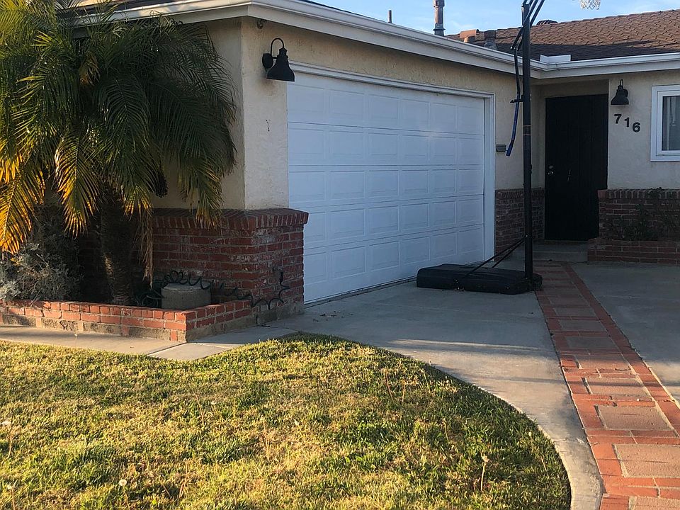 Front yard with large driveway and RV hookup