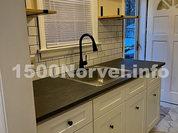 Updated kitchen and appliances including stackable washer and dryer