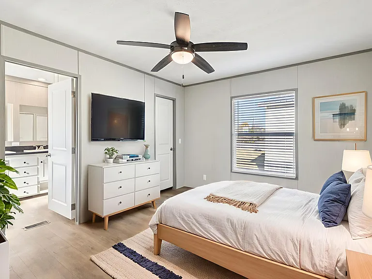 Spacious master bedroom filled with natural light, featuring modern finishes and direct access to a private ensuite bath.