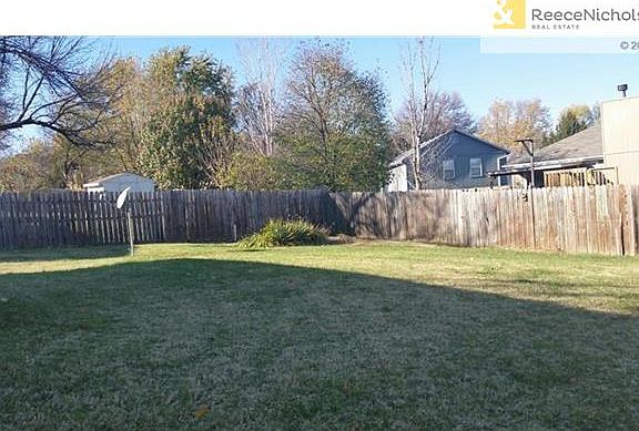 Large fenced backyard with concrete pad for shed w/electricity