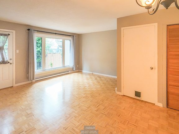 Living/Dining area showing entry closet and stairs to basement.