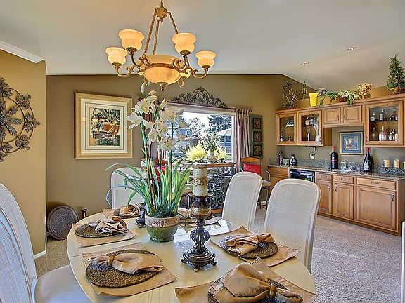 The formal dining room features a full service wet-bar complete with, 1” thick