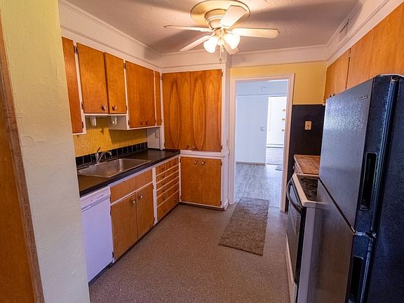 The galley kitchen leads to the dining room.