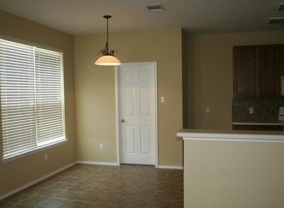 Breakfast area with hard tile, open to kitchen and family room.