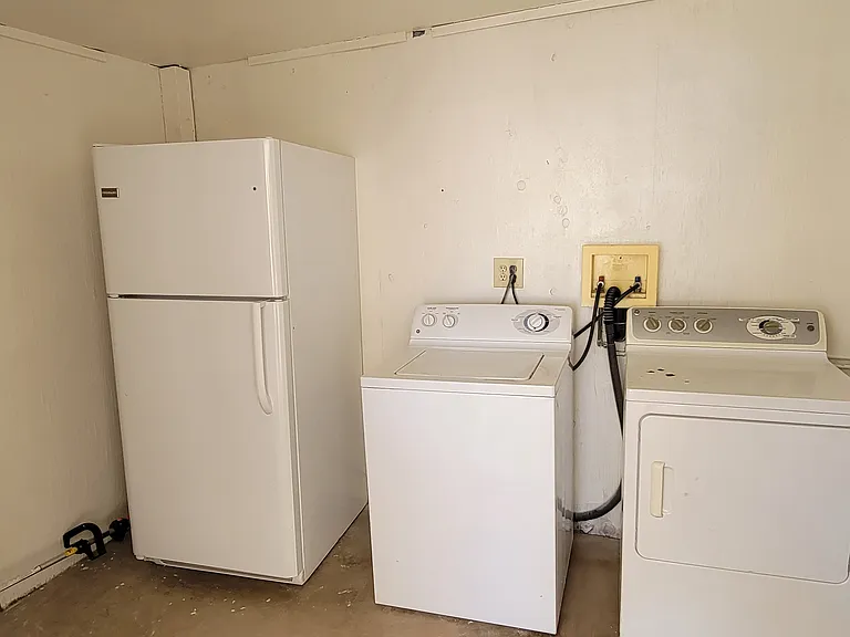 Laundry area, plus second refrigerator.