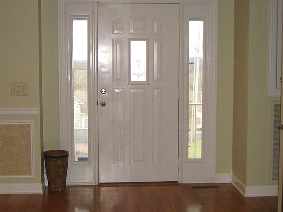 Entry Foyer Has Hardwood Floors & Front Door with Side Transoms