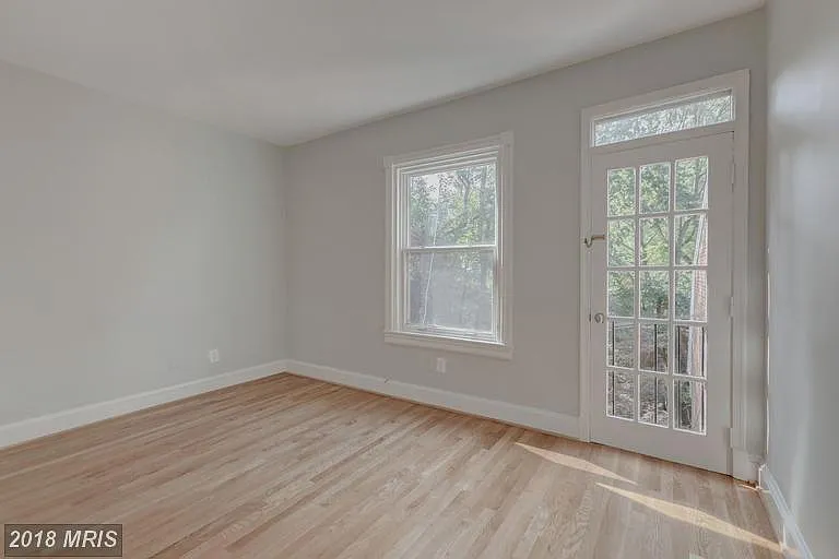 Main Bedroom. Window and Juliet balcony face back patio on first floor.