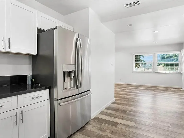 Beautifully updated kitchen with white shaker cabinetry, granite counters, brushed nickel pulls and handels, stainless appliances and more