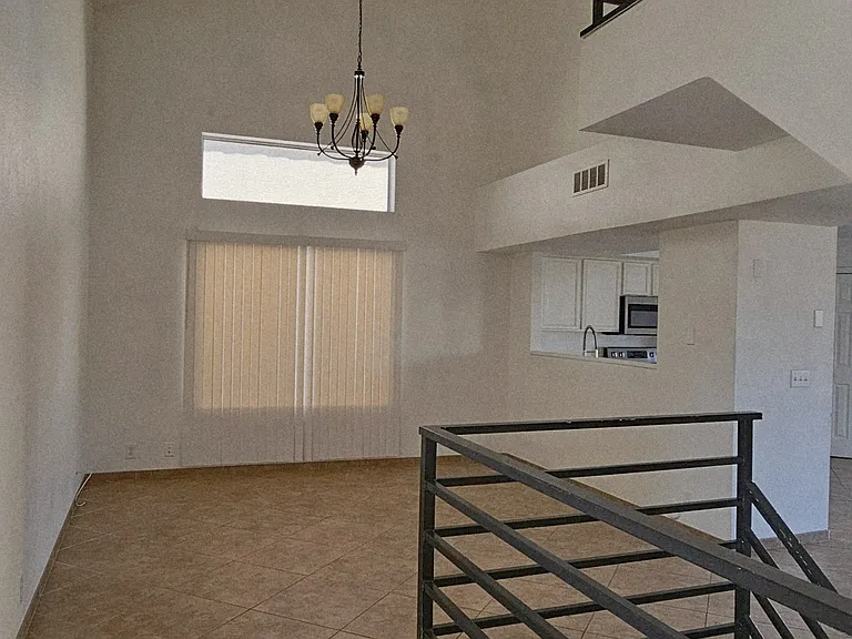 Grand entry with soaring ceilings, abundant natural light, and an open-concept layout. This inviting space sets the tone for the home with a bright and airy feel.