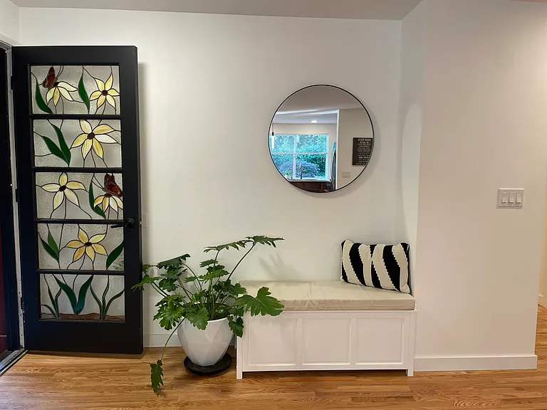 Live clutter free- to reduce entryway clutter with smart bench storage.
Quick mirror check as you head out the door.Entryway with built-in storage bench.