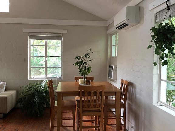 Dining area and new ac/heating unit on right wall.