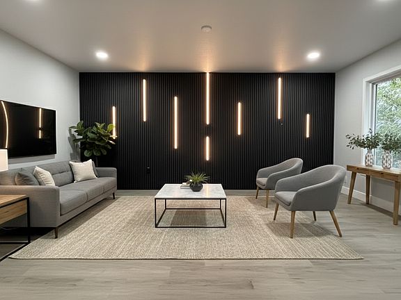 Large living room with view out into the front yard, paneled wall with LED lights!