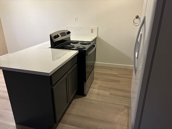 New cabinet island with brand new quartz counter tops, new oven and brand new hood.