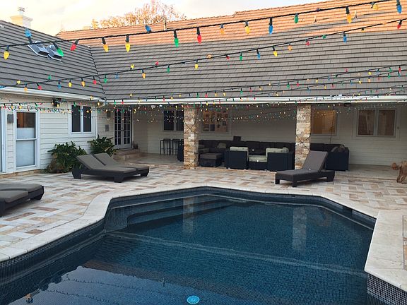 swimming pool in center of single story house.