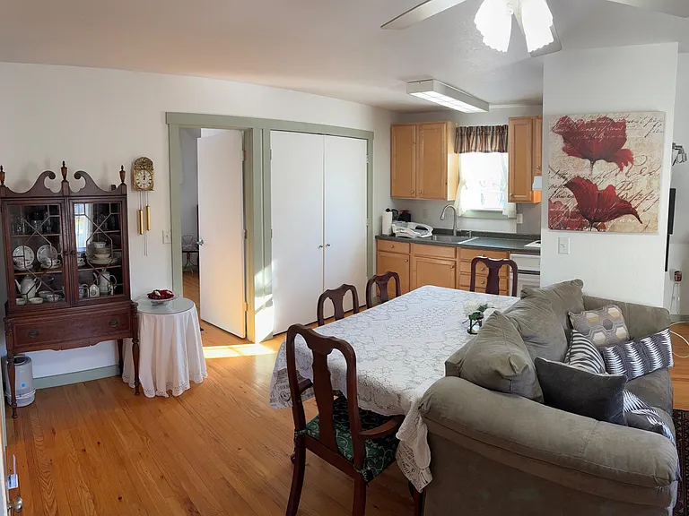 This apartment is cute and cozy with a very efficient use of space. This is the view of the Dining and Kitchen from the entry. Hardwood floors throughout and tile in the Bathroom.