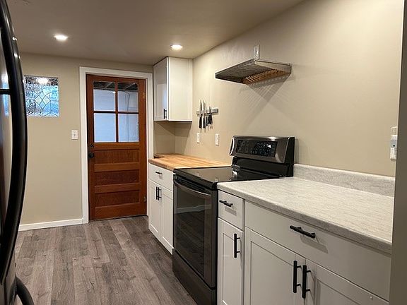 From kitchen door, stove and built-in butcher block.
