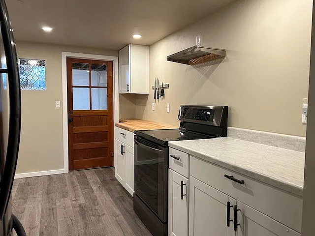 From kitchen door, stove and built-in butcher block.