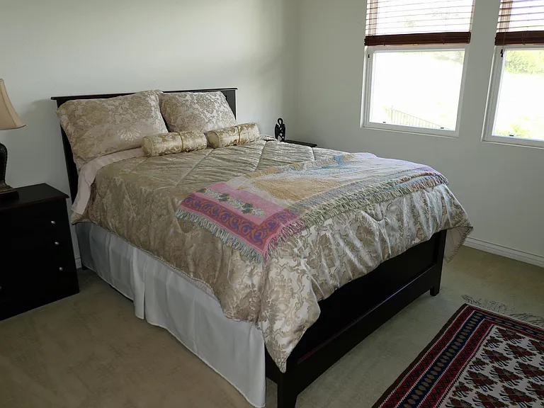 Bedroom #2 has a queen bed, chest of drawers, night stand, private bath (tub/shower), sink area, walk in closet.