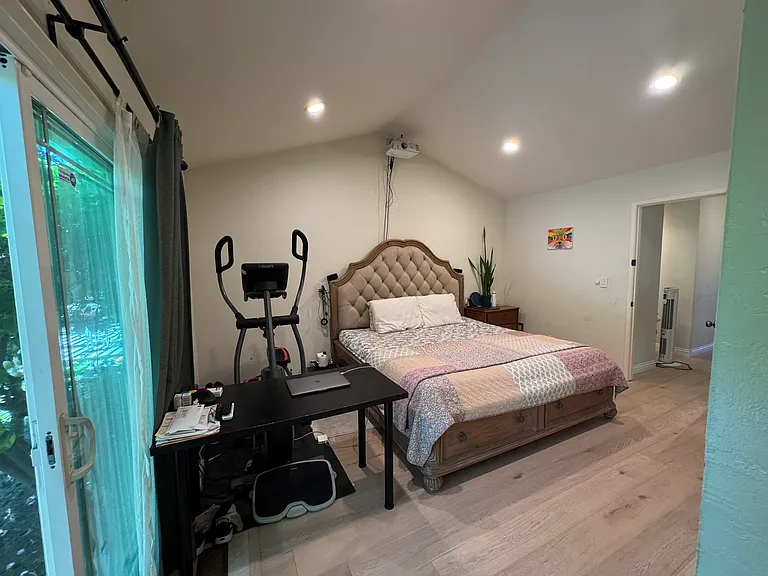 Master bedroom with backyard access, vaulted ceiling & recessed lights