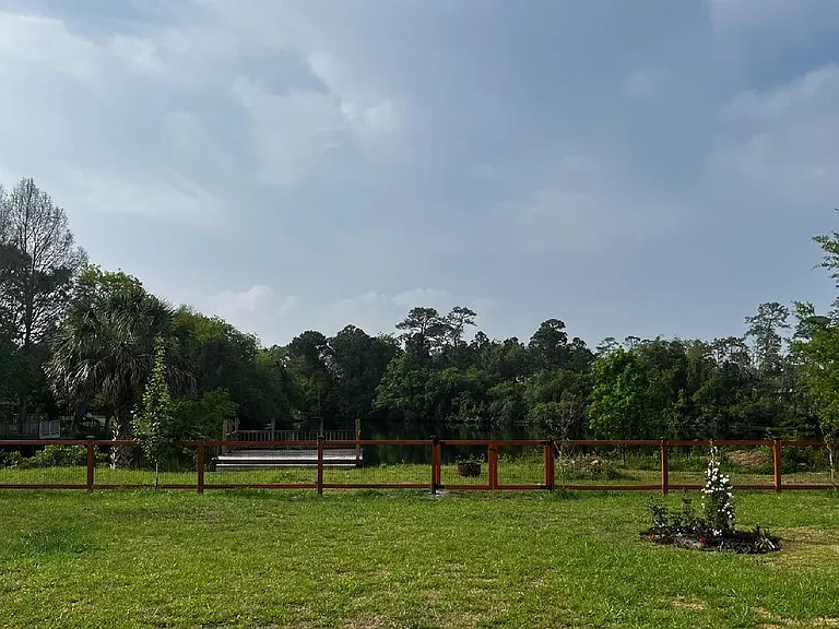 Large fenced-in back yard with new fence and lakefront access.